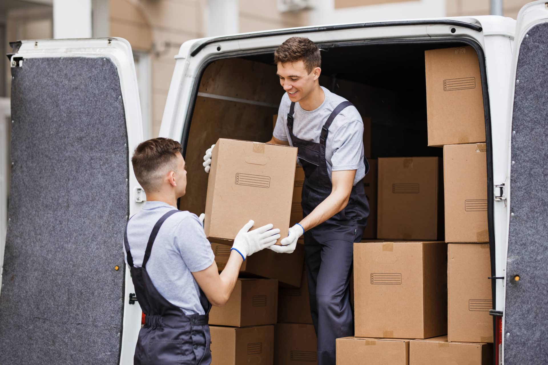 two-young-handsome-movers-wearing-uniforms-are-unloading-the-van-full-of-boxes-house-move-mover-2-e1694426476985.jpg